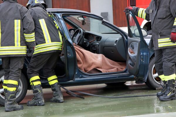 Firefighter team extracts the person from inside the car after a serious road accident - catastrophic injury attorneys at Saladino & Schaaf