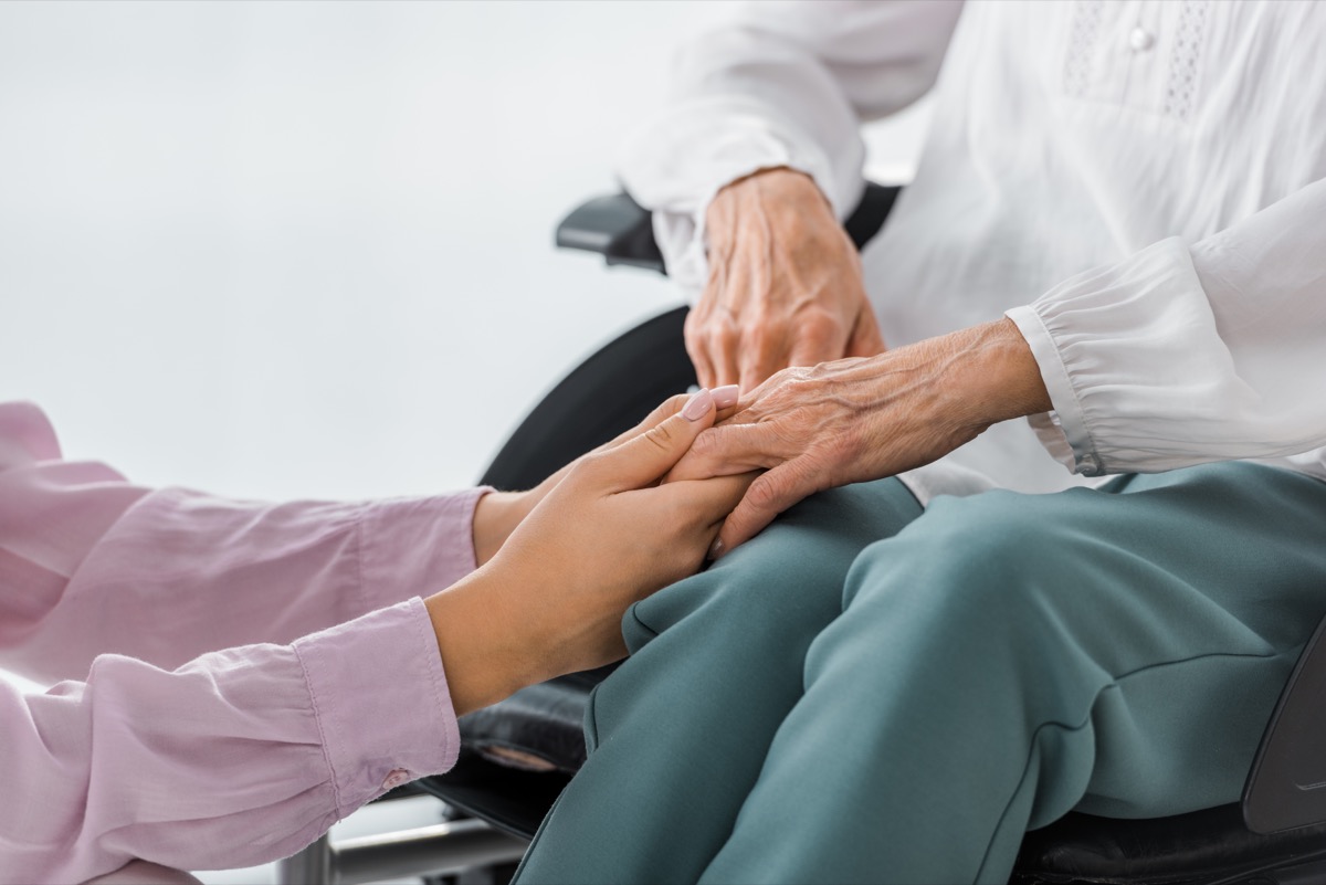 Holding hands with loved one in nursing home abuse situation.