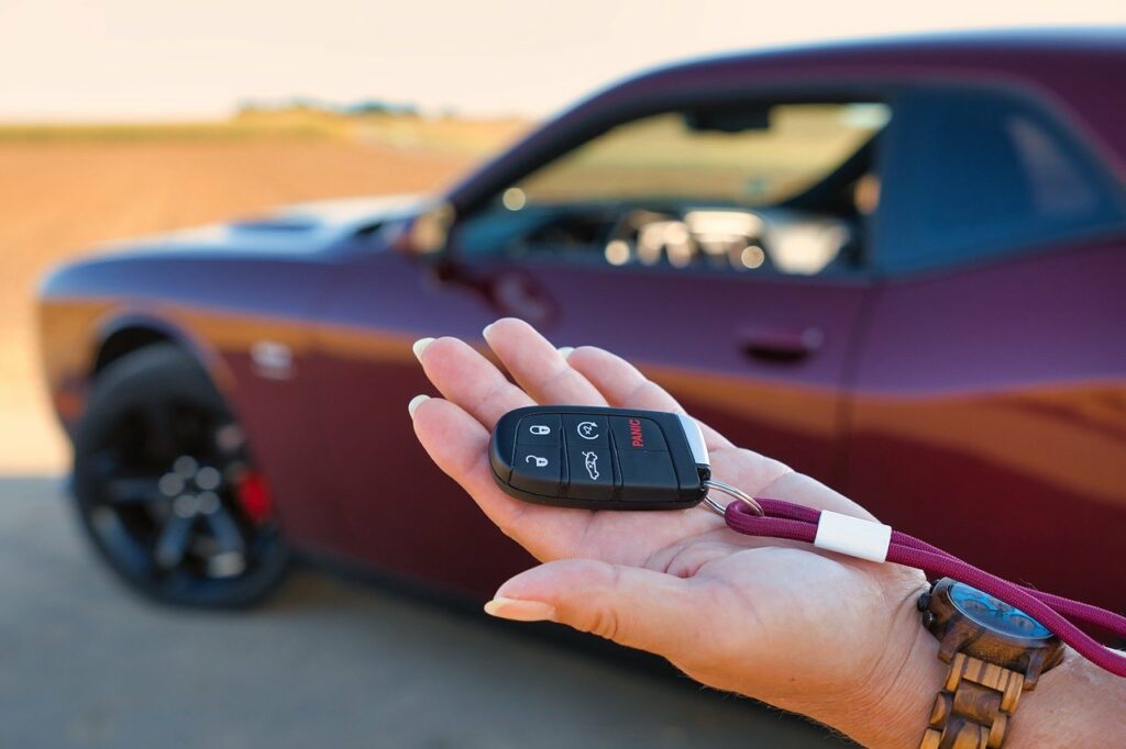 Woman holding keys to rental car. Kentucky Rental Car Accident Lawyers, Saladino & Schaaf.