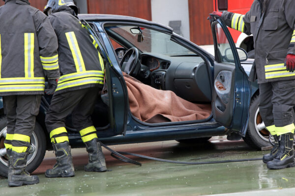 Firefighter team extracts the person from inside the car after a serious road accident - catastrophic injury attorneys at Saladino & Schaaf