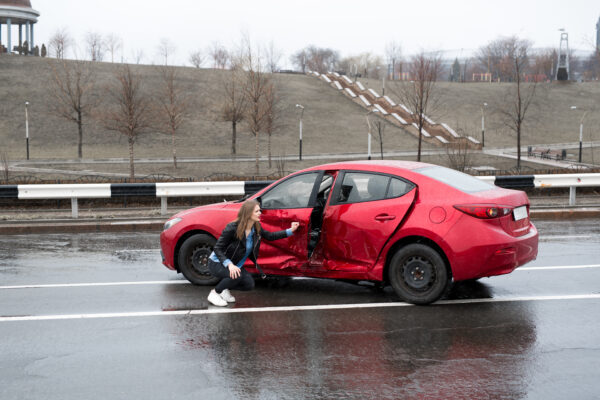 Woman next to car after being in a hit-and-run accident - Paducah personal injury lawyer, Saladino & Schaaf